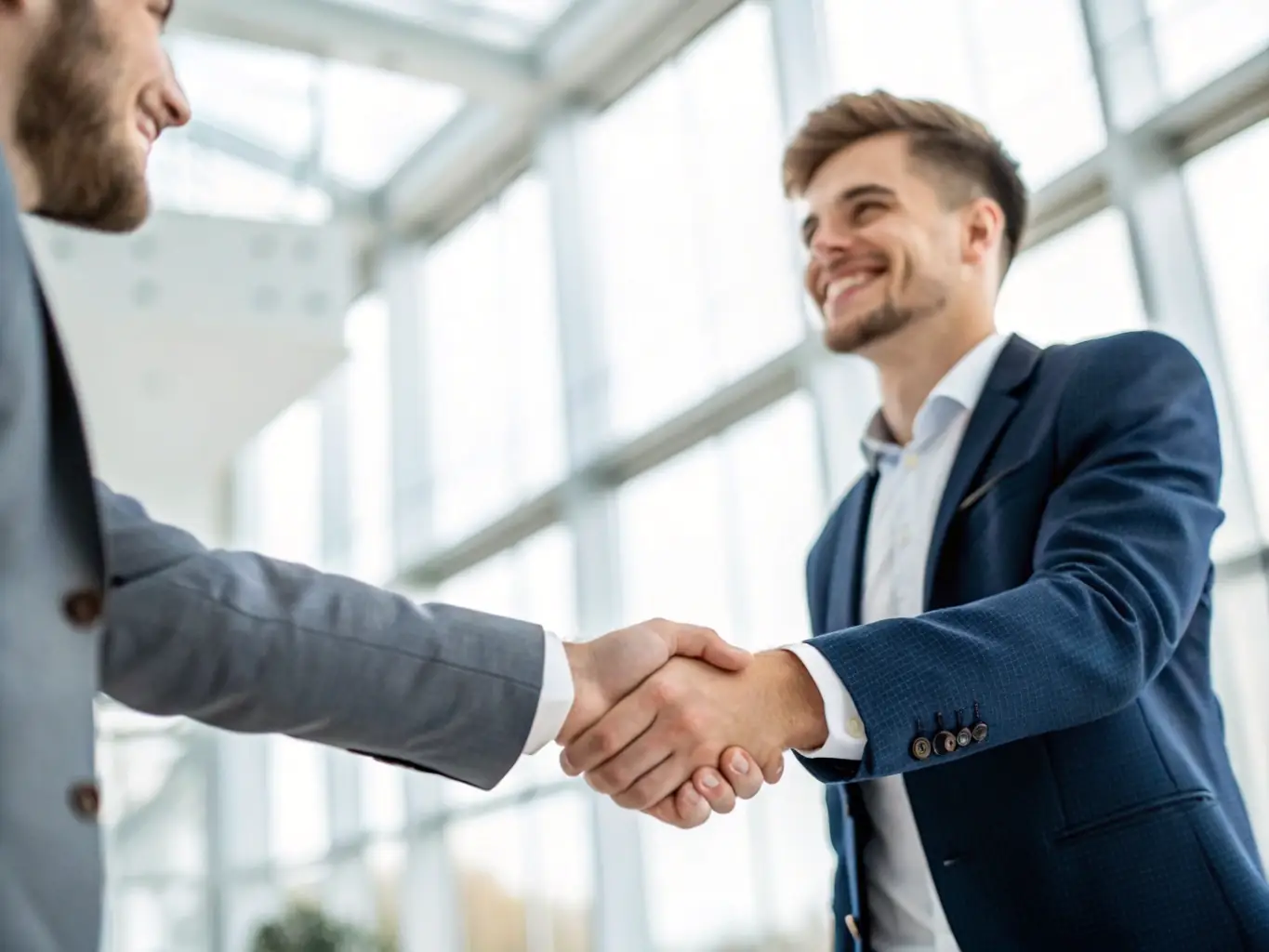 A digital illustration of a handshake between a student and an entrepreneur, representing the mentorship aspect of the MEXAS CHINGONES scholarship at Nikola Tesla University Institute.